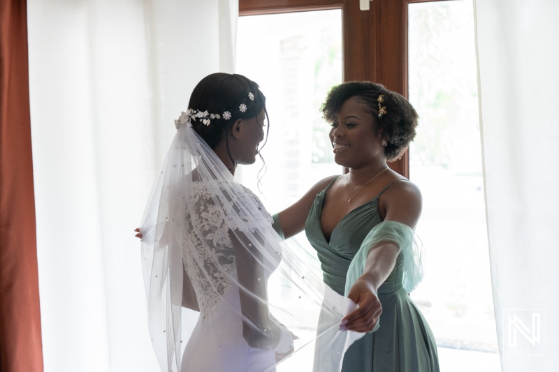 A bride and her maid of honor share a heartfelt moment in a sunlit room as they prepare for the wedding ceremony in a joyous celebration of friendship and love during the morning hours