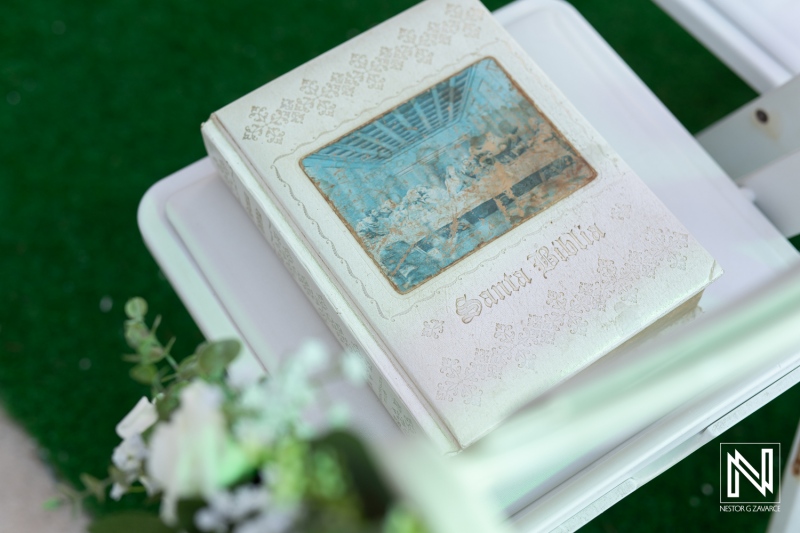 Elegant decorative book placed on white table during a serene outdoor gathering in a garden setting, capturing a relaxing moment in the early afternoon light