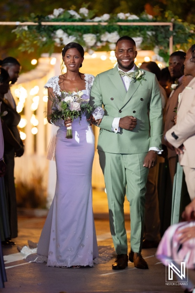 A joyful couple walks down the aisle, celebrating their union at a beautiful outdoor wedding ceremony in the evening light surrounded by family and friends