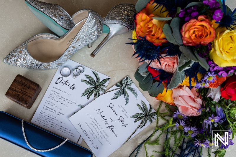 Wedding details display at Sunscape Curacao Resort featuring elegant shoes, rings, and vibrant flowers