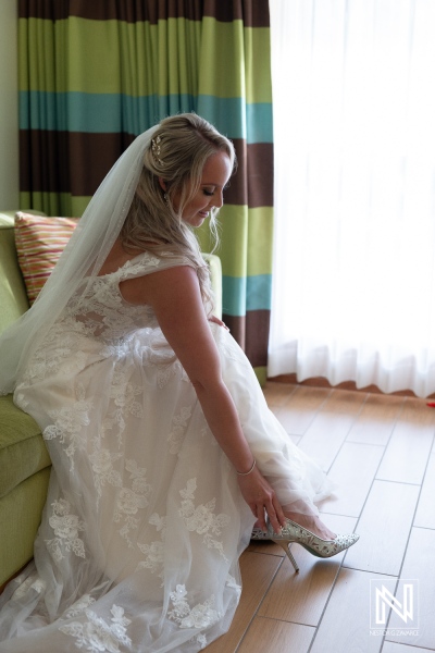 Stunning bride prepares for her wedding at Sunscape Curacao Resort with a beautiful view and elegant shoes