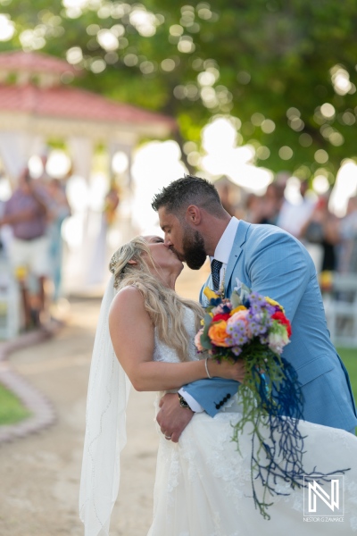 Beautiful wedding kiss at Sunscape Curacao Resort during a sunset ceremony surrounded by tropical scenery