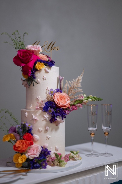 Stunning wedding cake adorned with flowers at Sunscape Curacao Resort during a beautiful wedding celebration