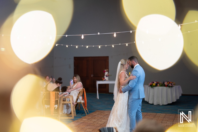 Couple shares their first dance during a romantic wedding at Sunscape Curacao Resort in Curacao, surrounded by family and friends