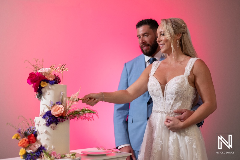 Couple celebrate special moment with wedding cake at Sunscape Curacao Resort during their romantic ceremony