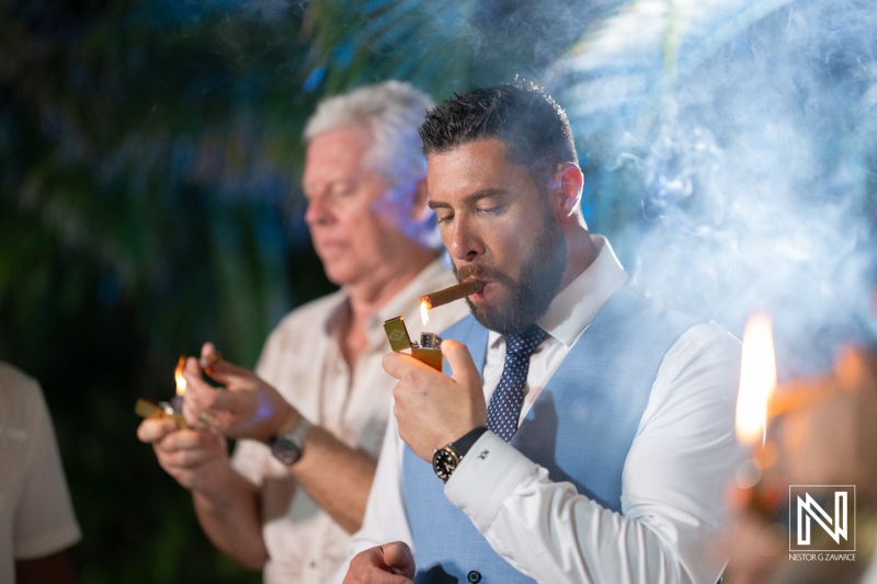 Celebration of love during a wedding ceremony at Sunscape Curacao Resort with guests enjoying cigars in a tropical setting