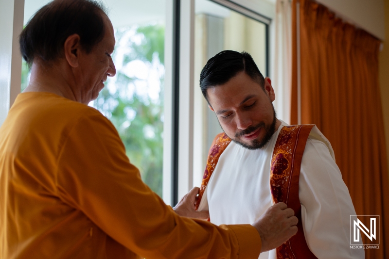 Groom getting into attire