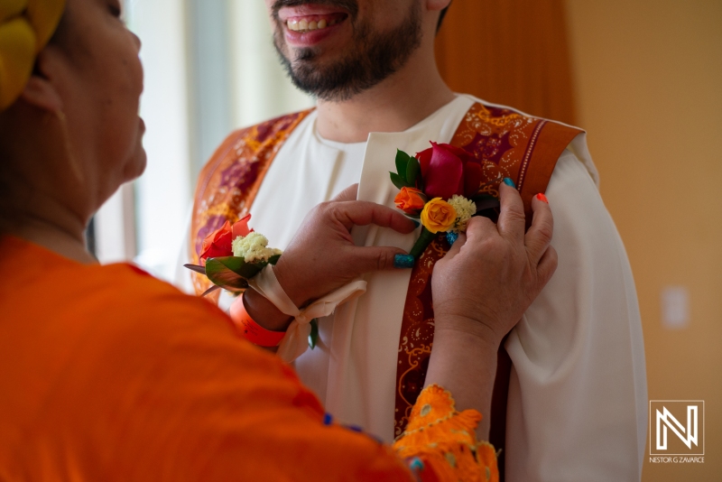 Groom getting into attire