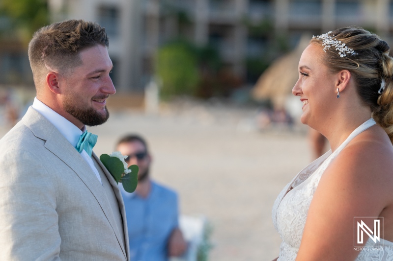 A Joyful Couple Exchanges Vows During Their Beach Wedding at Sunset, Surrounded by Friends and Family in a Beautiful Outdoor Setting