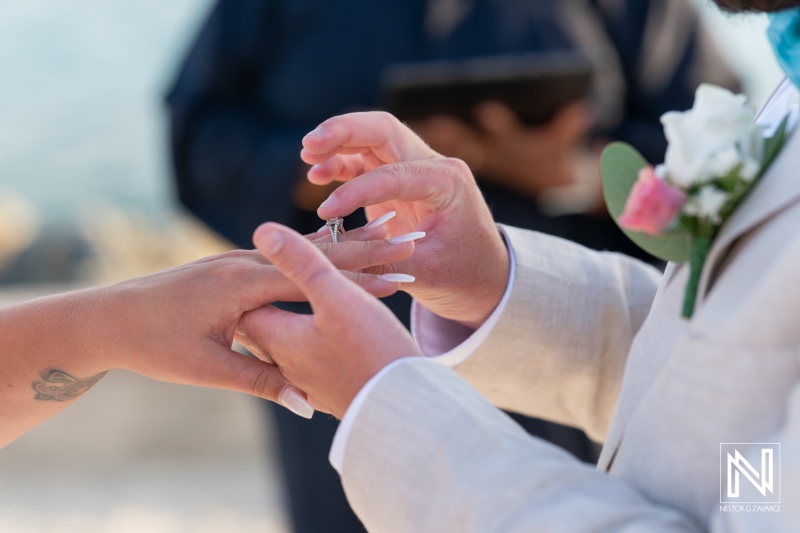 A Bride and Groom Exchanging Wedding Rings During a Serene Beach Ceremony at Sunset, Surrounded by Gentle Waves and Soft Ocean Breeze