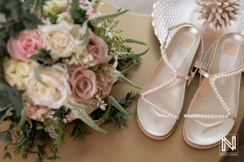 Elegant bridal shoes and stunning bouquet at sunset wedding celebration in Curacao