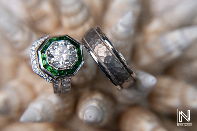 Glistening wedding rings showcase love amidst the natural beauty of Curacao's sunset at a coastal resort