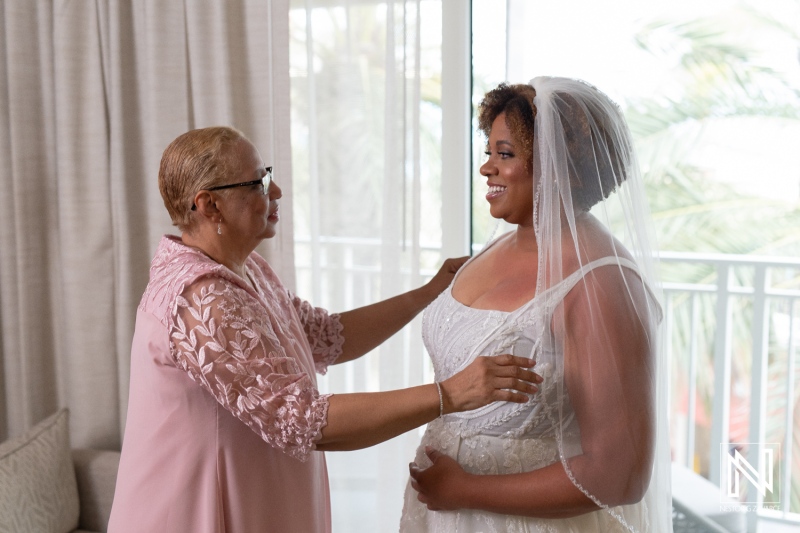 Bridal moments shared between mother and daughter before a sunset wedding at Renaissance Wind Creek Curacao Resort