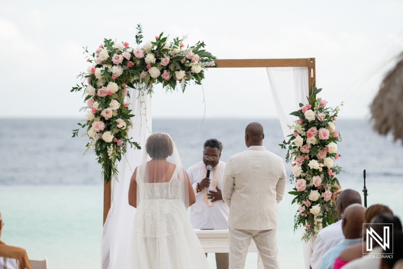 Couple exchanges vows during a romantic sunset wedding ceremony at Renaissance Wind Creek Curacao Resort