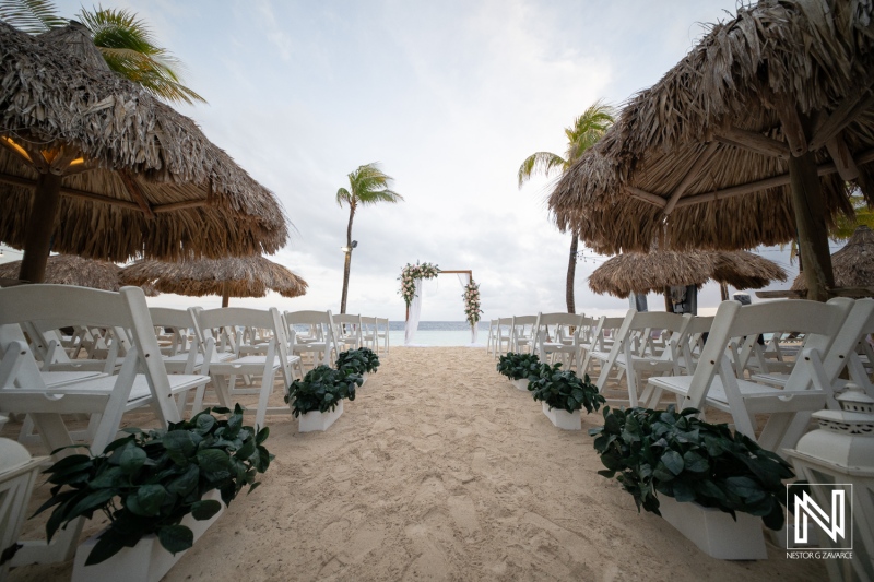 Ceremony setup on sandy beach at sunset for a wedding at Renaissance Wind Creek Curacao Resort with tropical decor and charming details