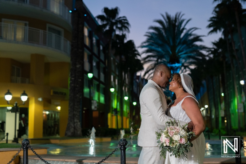 Beautiful couple shares a romantic moment during their wedding at Renaissance Wind Creek Curacao Resort at sunset