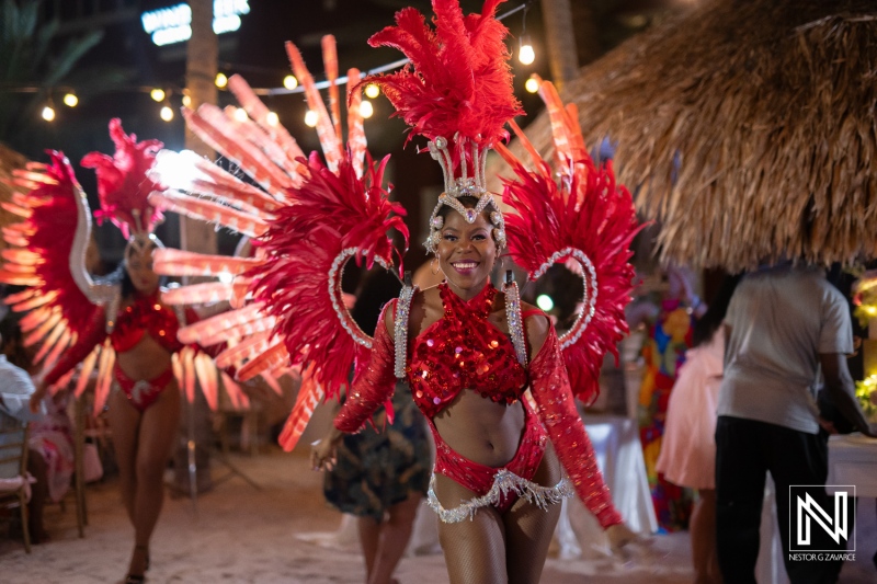 Vibrant celebration during a wedding at a beach venue in Curacao under the warm glow of the sunset