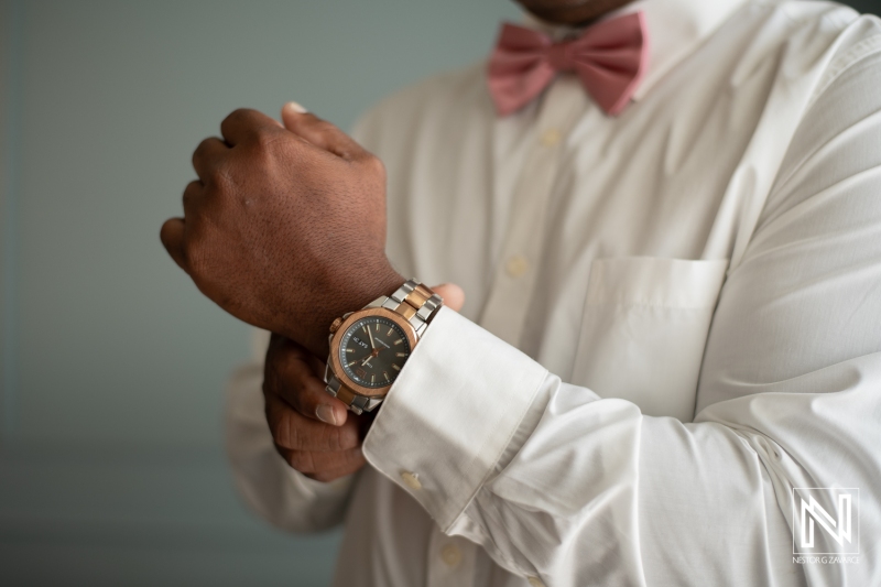 Groom getting into attire