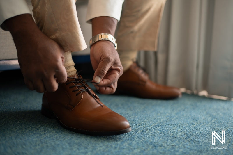 Groom getting into attire