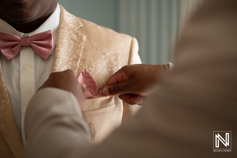 Groom getting into attire