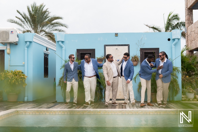 Groom and groomsmen prepare for a wedding celebration at Playa Hunku in Curacao on a cloudy day