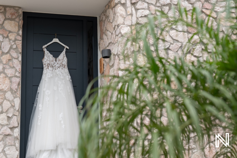 Elegant wedding dress hanging before a beautiful ceremony at Playa Hunku in Curacao, capturing the essence of romance and celebration