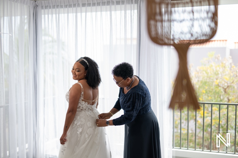 Wedding preparations at Playa Hunku in Curacao showcase a bride getting ready with assistance from her mother on a beautiful day