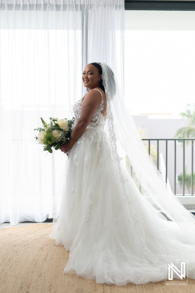 Beautiful bride in stunning wedding dress at Playa Hunku, Curacao, preparing for a magical ceremony by the beach