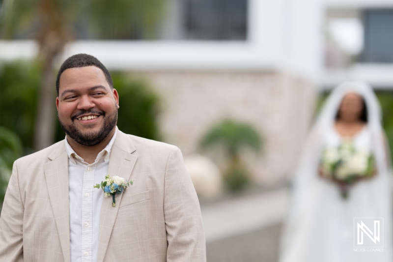 Couple celebrates their love during a beach wedding ceremony at Playa Hunku in Curacao under sunny skies