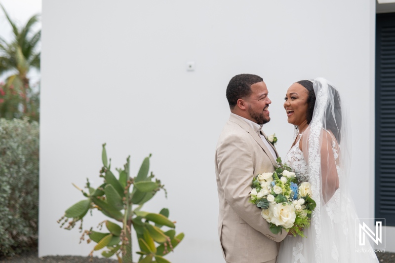 Couple celebrating their love with joy at a wedding ceremony in Playa Hunku, Curacao surrounded by beautiful tropical scenery