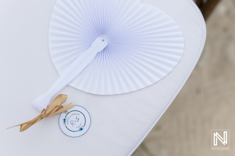 Wedding ceremony preparations at Playa Hunku in Curacao featuring elegant fans and thoughtful details for guests