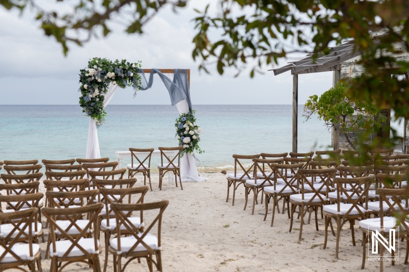 Beautiful beach wedding setup at Playa Hunku in Curacao with chairs and floral arch ready for ceremony