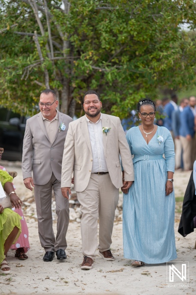 Couple arrives together with family for a wedding ceremony at Playa Hunku, Curacao during a sunny afternoon