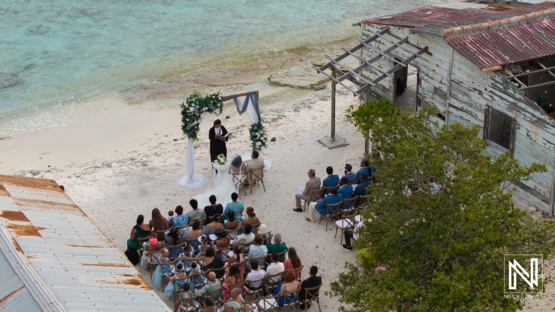Wedding ceremony at Playa Hunku overlooking the serene waters, capturing love and joy on a beautiful day in Curacao