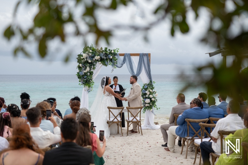Couple exchanges vows during a romantic beach wedding ceremony at Playa Hunku in Curacao