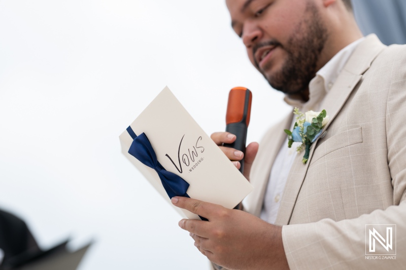 Groom reading vows during a beautiful wedding ceremony at Playa Hunku, Curacao with a focus on love and commitment between the couple