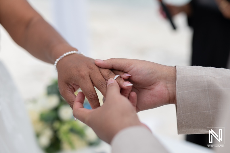 Romantic wedding ceremony at Playa Hunku in Curacao with heartfelt ring exchange and lively coastal backdrop