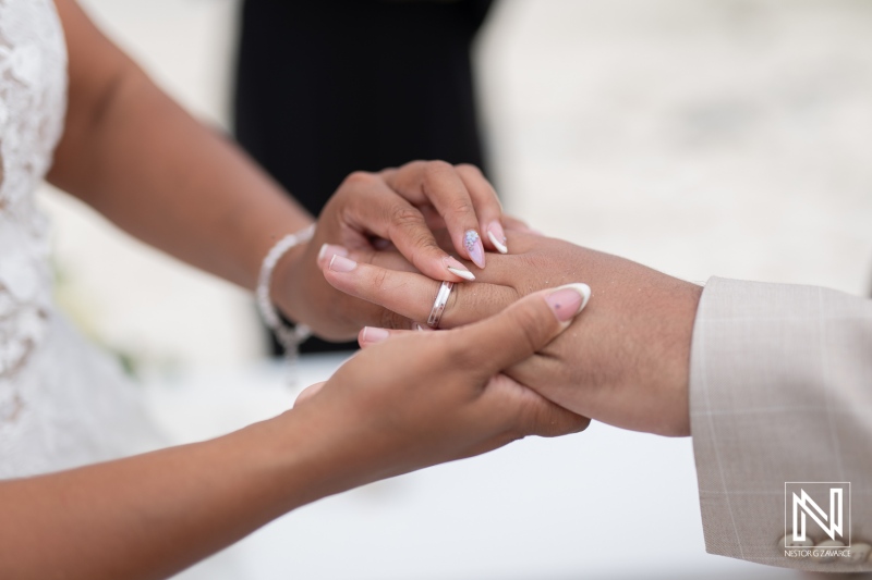 Couple exchanging wedding vows in picturesque Playa Hunku, Curacao during a serene sunset ceremony