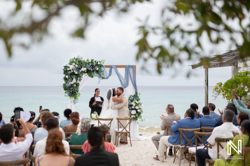 Wedding celebration at Playa Hunku in Curacao with stunning ocean backdrop and heartfelt vows exchanged between the couple