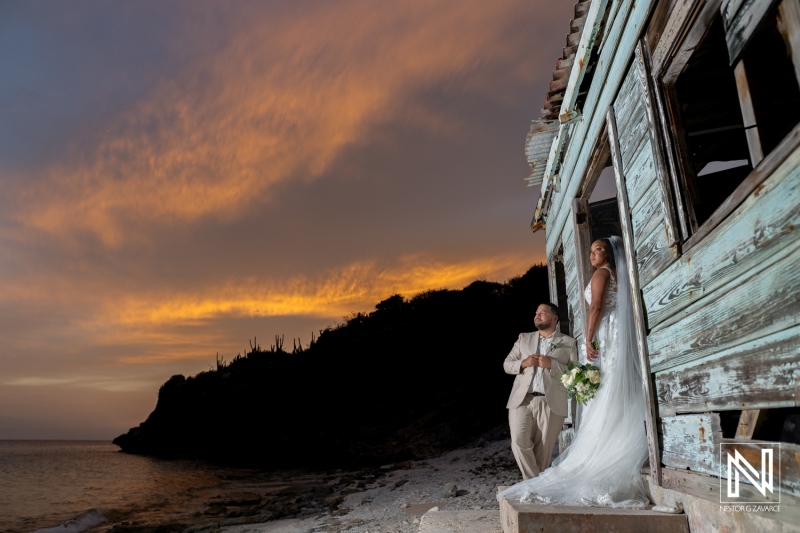 Couple enjoys romantic sunset at their wedding in Playa Hunku, Curacao surrounded by stunning natural beauty and historic architecture