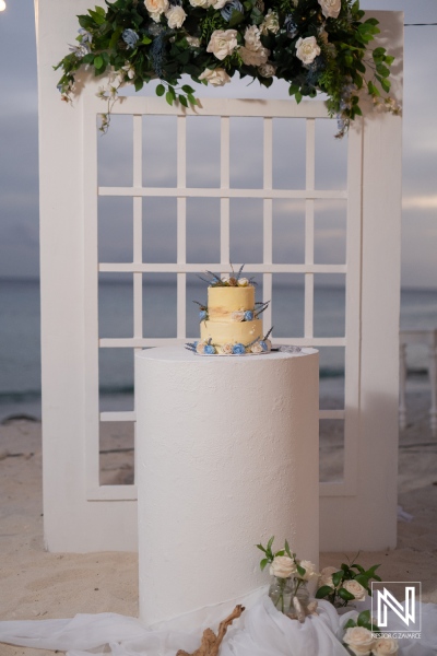 Elegant wedding cake display at Playa Hunku in Curacao during a romantic ceremony by the beach at twilight