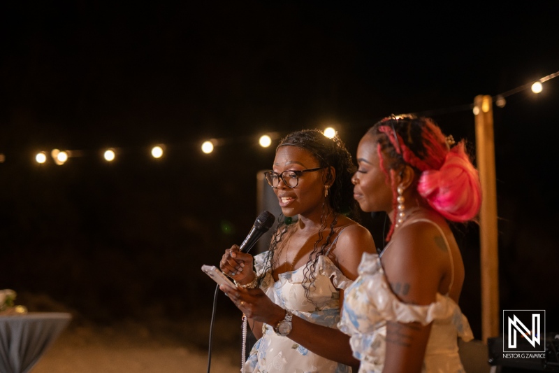 Celebratory speeches shared by friends during a beautiful wedding at Playa Hunku in Curacao under twinkling lights