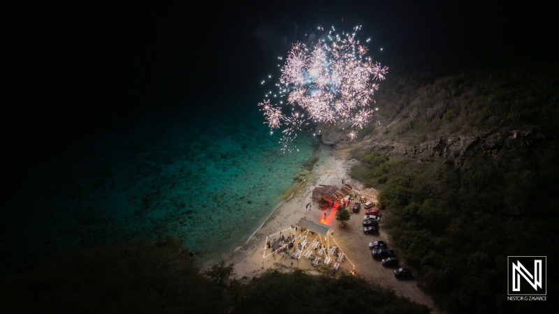 Wedding celebration under fireworks at Playa Hunku in Curacao, creating a magical atmosphere on a serene night