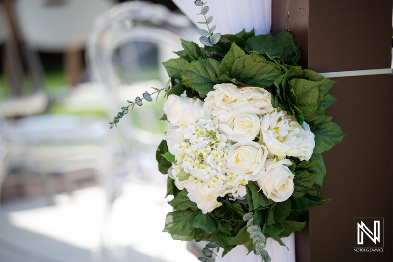 Beautiful floral arrangement at a wedding celebration in Curacao with a serene backdrop of the Acoya Curacao Resort