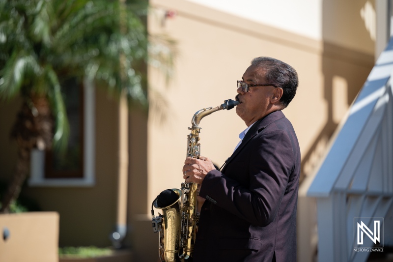Saxophonist performing at a wedding celebration in Acoya Curacao Resort with beautiful tropical surroundings