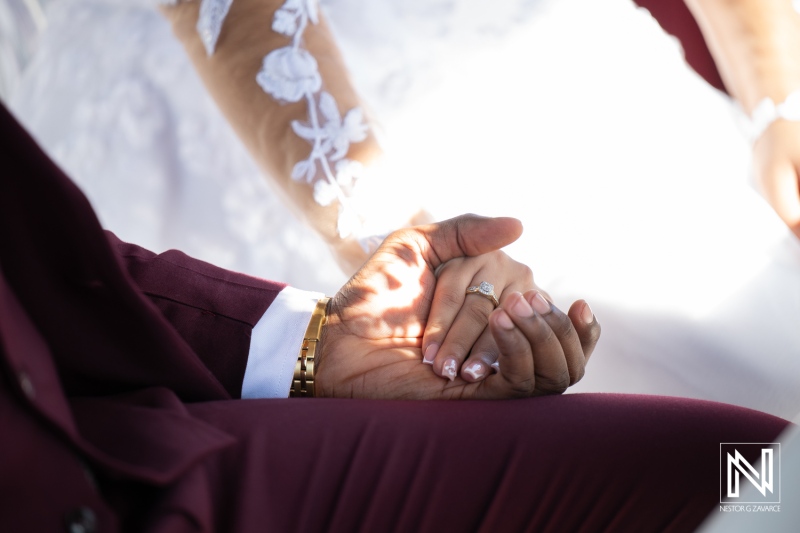 Couple holding hands during wedding at Acoya Curacao Resort after photoshoot in stunning locations