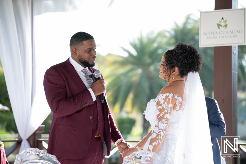 Couple exchanges vows during a beautiful wedding ceremony at Acoya Curacao Resort in a vibrant and scenic setting