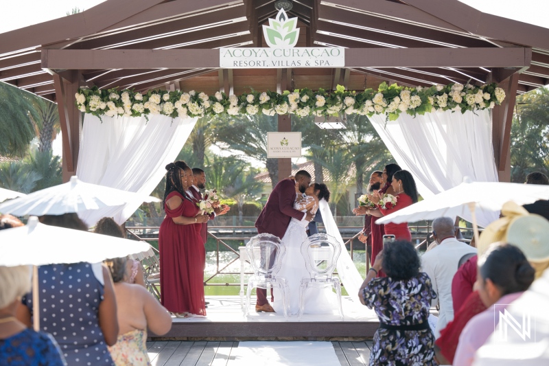 Ceremony at Acoya Curacao Resort with stunning backdrop and joyful guests celebrating love and unity