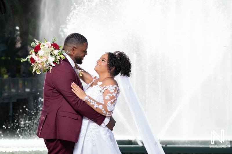 Celebrating love at Acoya Curacao Resort with joyful newlyweds in front of a beautiful fountain