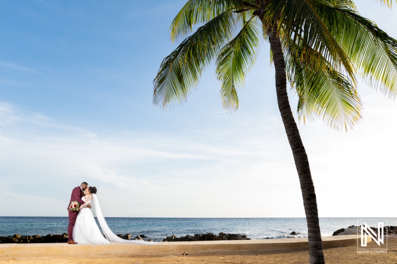 Couple enjoys a romantic moment on the beach during their wedding in Curacao at Acoya Resort